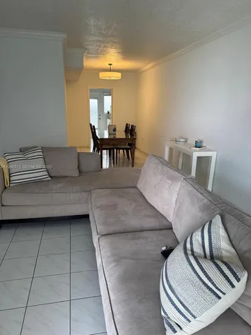 a living room with furniture and a piano