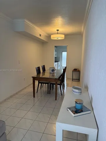 a dining room with furniture and a chandelier