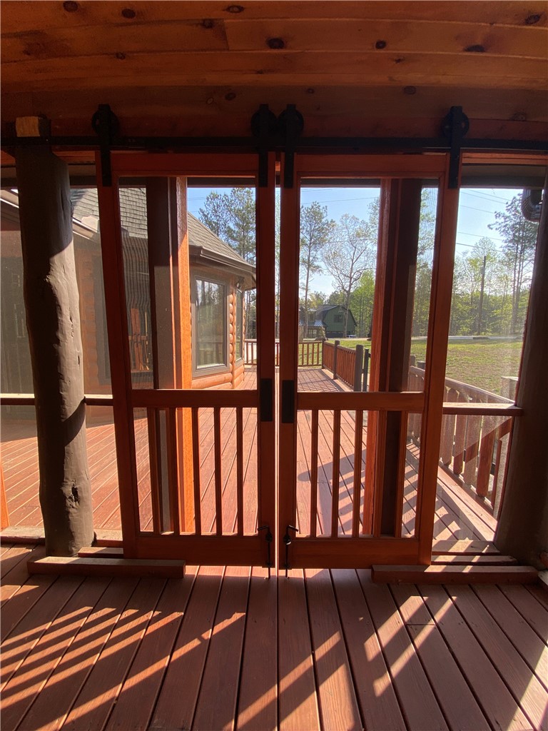 128 McAlister Road West Union, SC 29696 - Photo 13 of 40 Gaze upon the picturesque surroundings from this spacious, well-lit deck, complete with sturdy wooden railings.