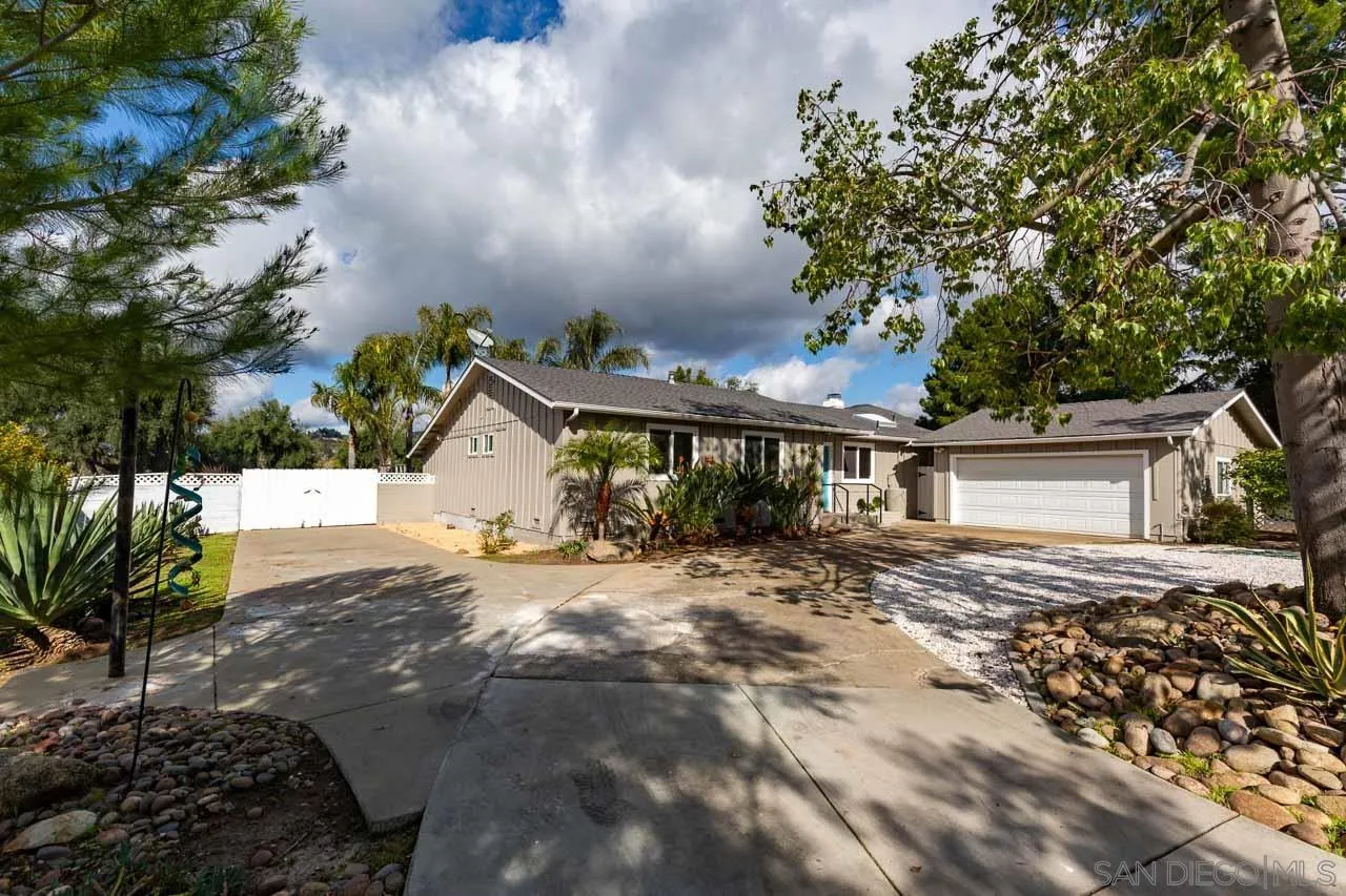 a view of a house with a tree in the background