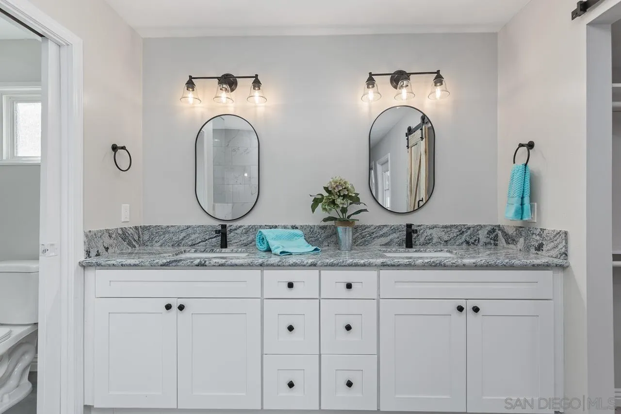 2922 Olive View Road Alpine, CA 91901 - Photo 17 of 34 a bathroom with a granite countertop double vanity sink and a mirror