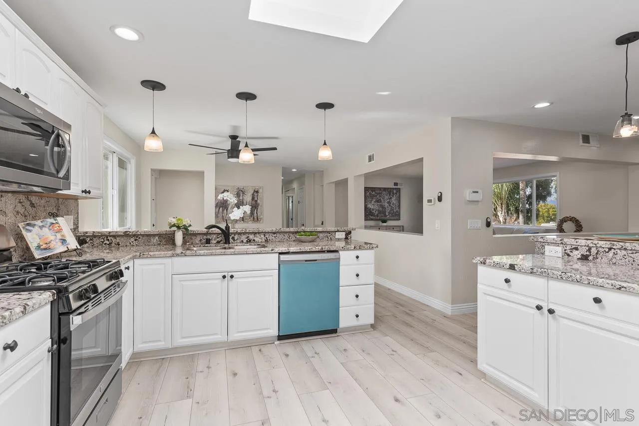 2922 Olive View Road Alpine, CA 91901 - Photo 6 of 34 a kitchen with stainless steel appliances kitchen island granite countertop a sink and cabinets