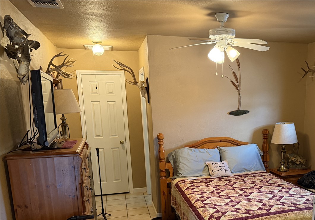 104 Jonathan Street Three Rivers, TX 78071 - Photo 12 of 17 a bedroom with a bed and ceiling fan