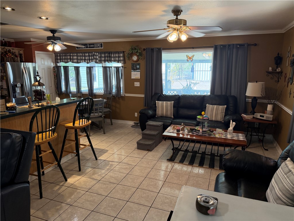 104 Jonathan Street Three Rivers, TX 78071 - Photo 4 of 17 a living room with furniture a chandelier and a window