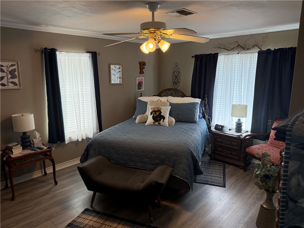 104 Jonathan Street Three Rivers, TX 78071 - Photo 6 of 17 a bedroom with a bed and wooden floor