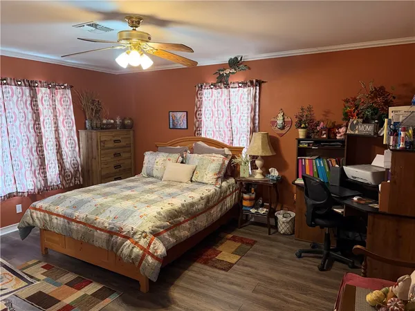 a bedroom with a bed a window and dresser