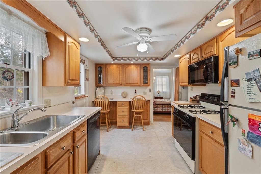 116 Virginia Road Pittsburgh, PA 15237 - Photo 12 of 29 a kitchen with stainless steel appliances a stove sink microwave and cabinets