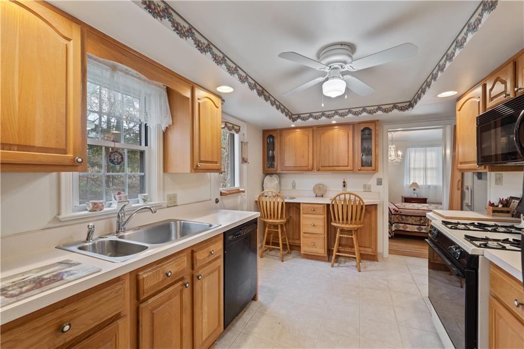 116 Virginia Road Pittsburgh, PA 15237 - Photo 13 of 29 a kitchen with furniture a stove a sink and a microwave