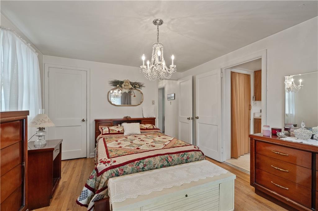 116 Virginia Road Pittsburgh, PA 15237 - Photo 16 of 29 a bedroom with a bed and a chandelier