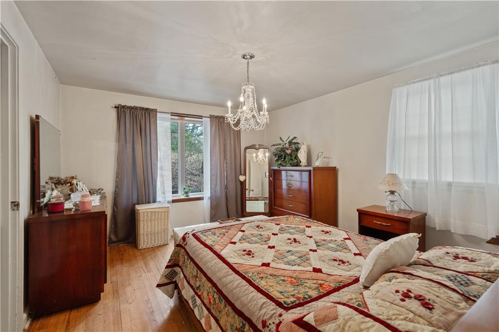 116 Virginia Road Pittsburgh, PA 15237 - Photo 17 of 29 a bedroom with a bed and a chandelier