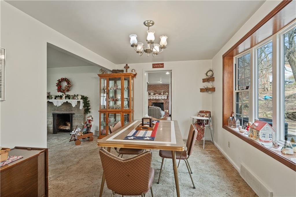 116 Virginia Road Pittsburgh, PA 15237 - Photo 7 of 29 a living room with furniture a chandelier and a flat screen tv