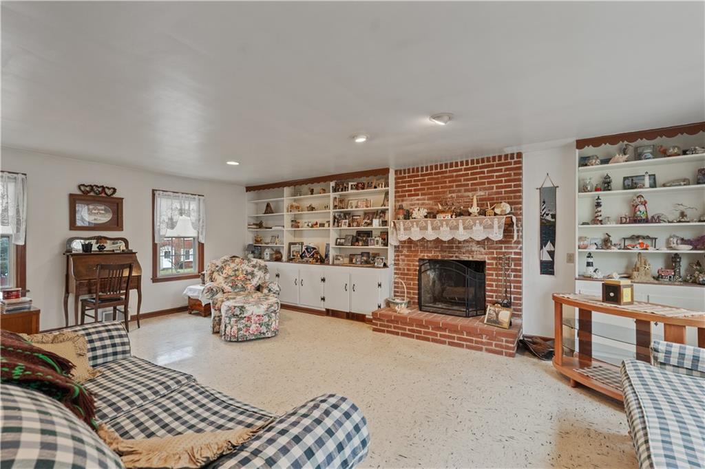 116 Virginia Road Pittsburgh, PA 15237 - Photo 10 of 29 a living room with furniture a fireplace and a flat screen tv