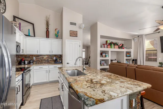 a bedroom with a bed and a view of kitchen
