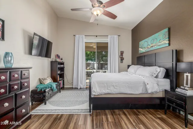 a bedroom with a bed and a flat screen tv