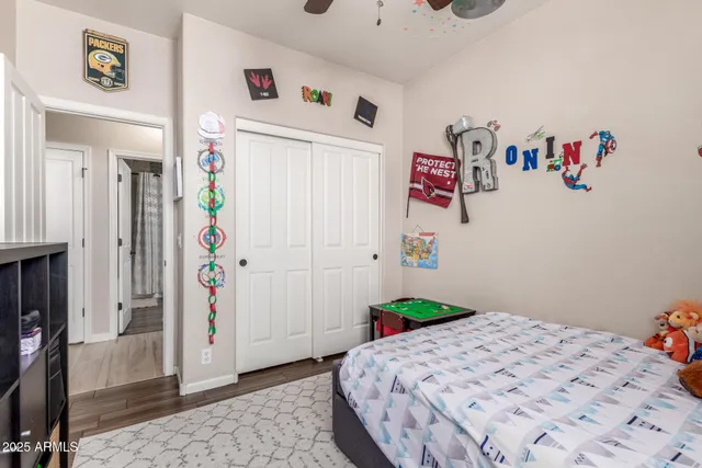 a bathroom with a granite countertop sink a toilet a mirror and shower