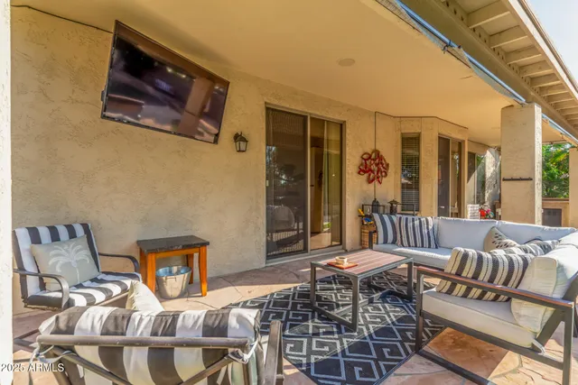 a building outdoor space with patio furniture and potted plants
