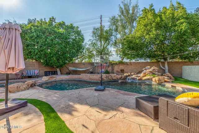 a view of a house with pool and sitting area
