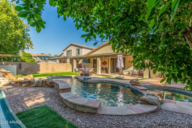 a view of a backyard with table and chairs and a fire pit