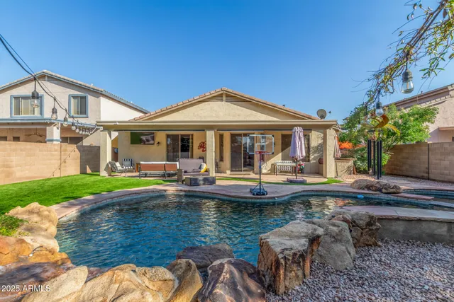 a view of a house with a yard patio and swimming pool