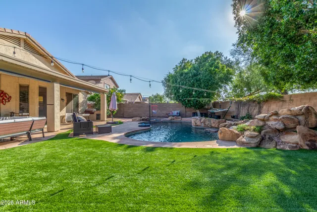 a view of a backyard with sitting area