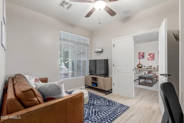 a living room with furniture and wooden floor