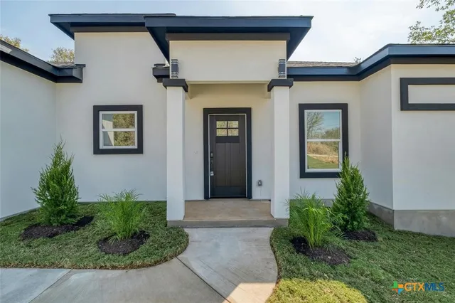 a front view of a house with garden