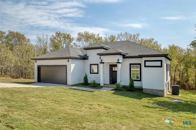 a front view of a house with a yard