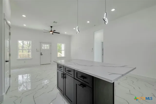 a bathroom with a sink shower and a mirror