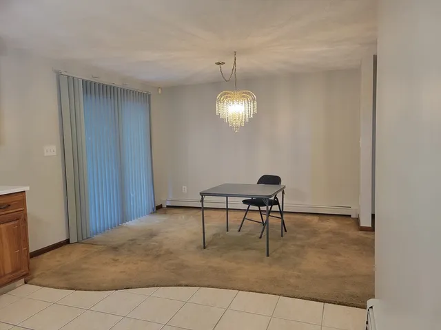 a view of a workspace with furniture and a chandelier fan