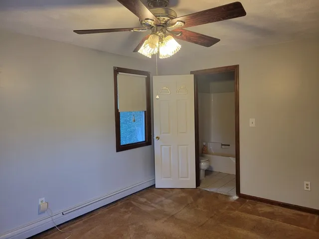 an empty room with closet and a chandelier fan