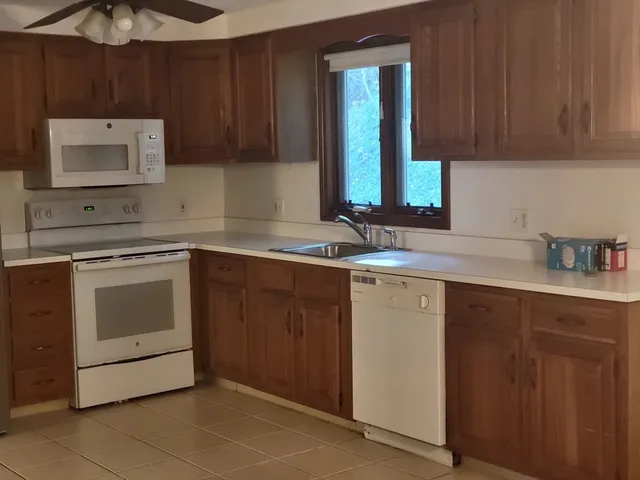 a kitchen with a sink stove and cabinets