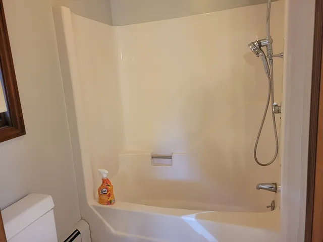 a bathroom with a bathtub and a shower