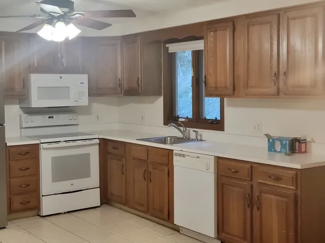 a kitchen with a sink cabinets and appliances