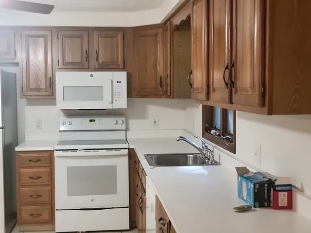 a kitchen with cabinets and a stove top oven