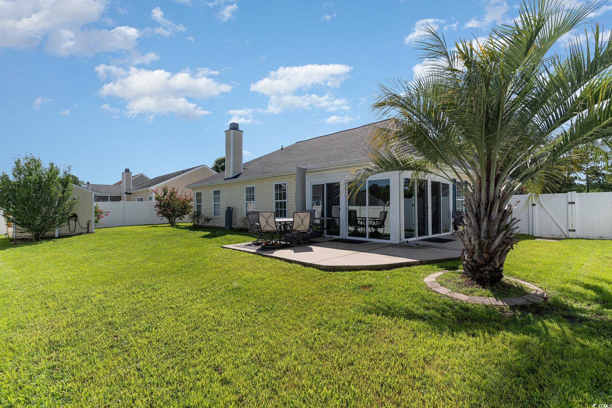 625 Seth Lane Longs, SC 29568 - Photo 28 of 34 Rear view of house featuring a patio and a lawn