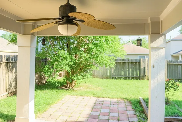 a swimming pool with yard next to a yard
