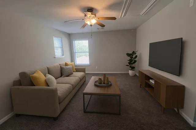 a living room with furniture and a flat screen tv