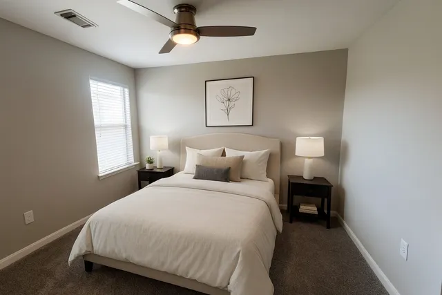 a bedroom with bed and window