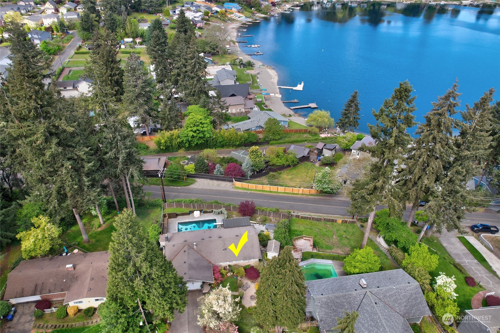 an aerial view of a house a yard and lake view