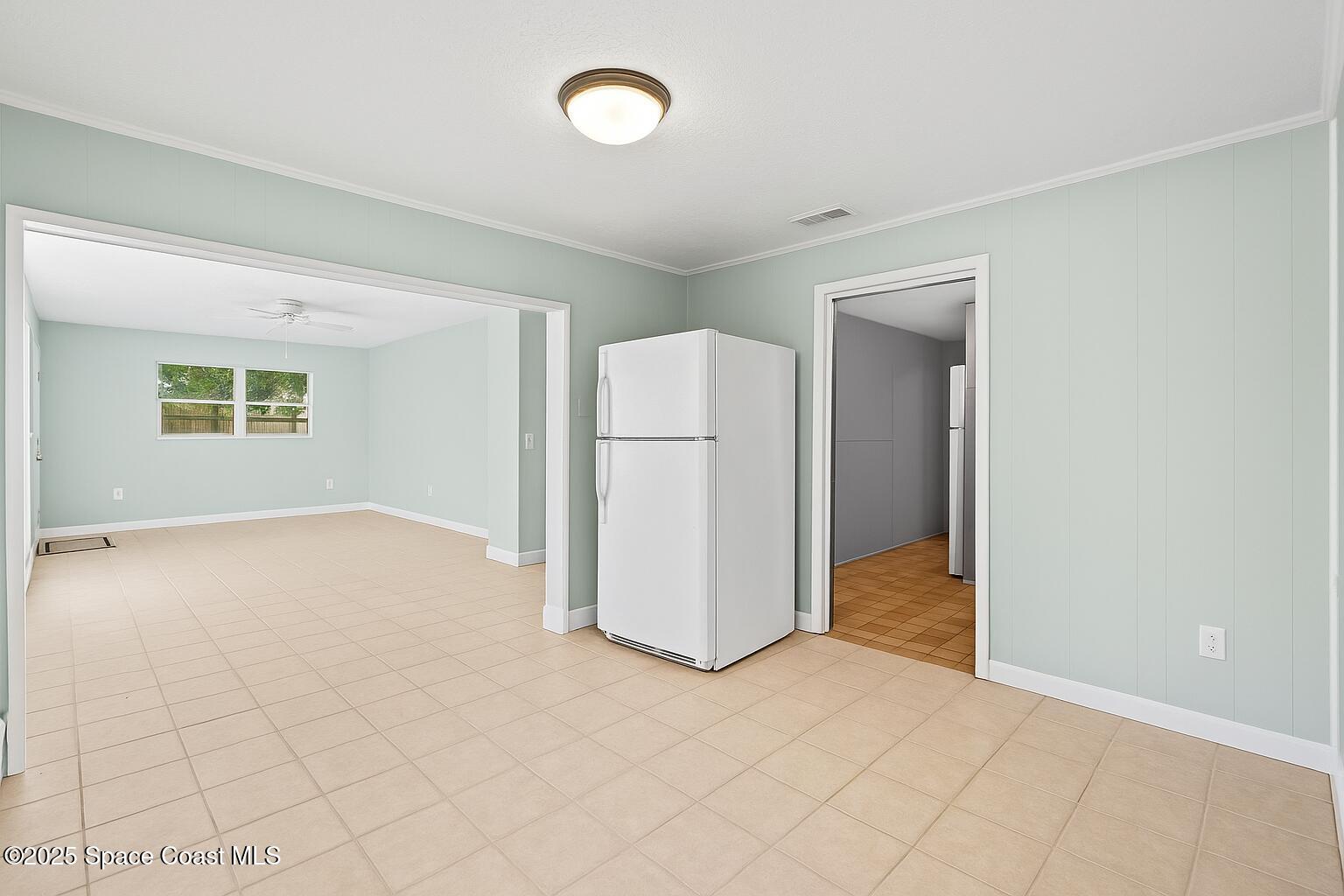 2902 Emory Street Melbourne, FL 32901 - Photo 11 of 46 an empty room with windows and refrigerator