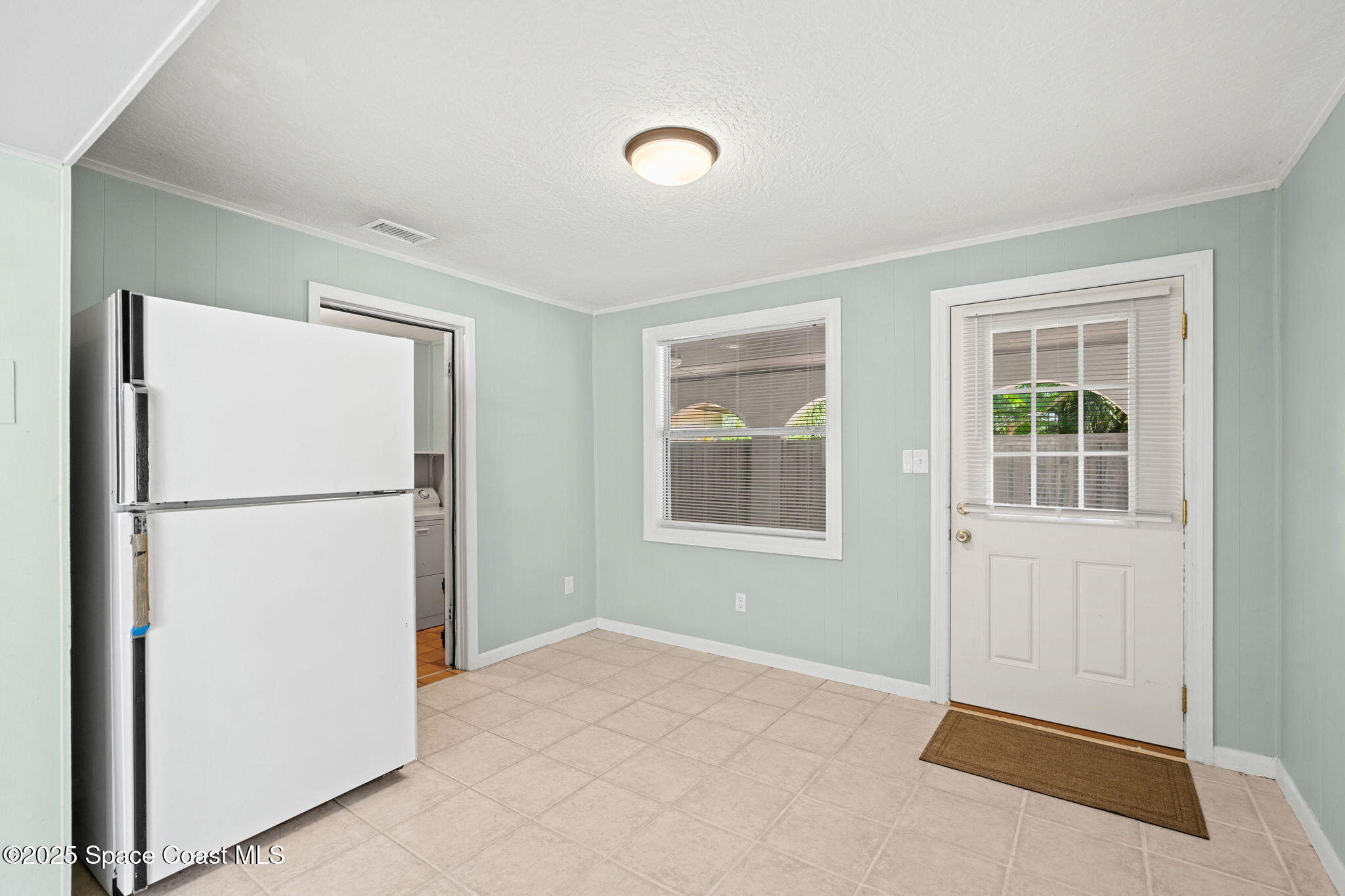 2902 Emory Street Melbourne, FL 32901 - Photo 12 of 46 a view of empty room with windows and refrigerator