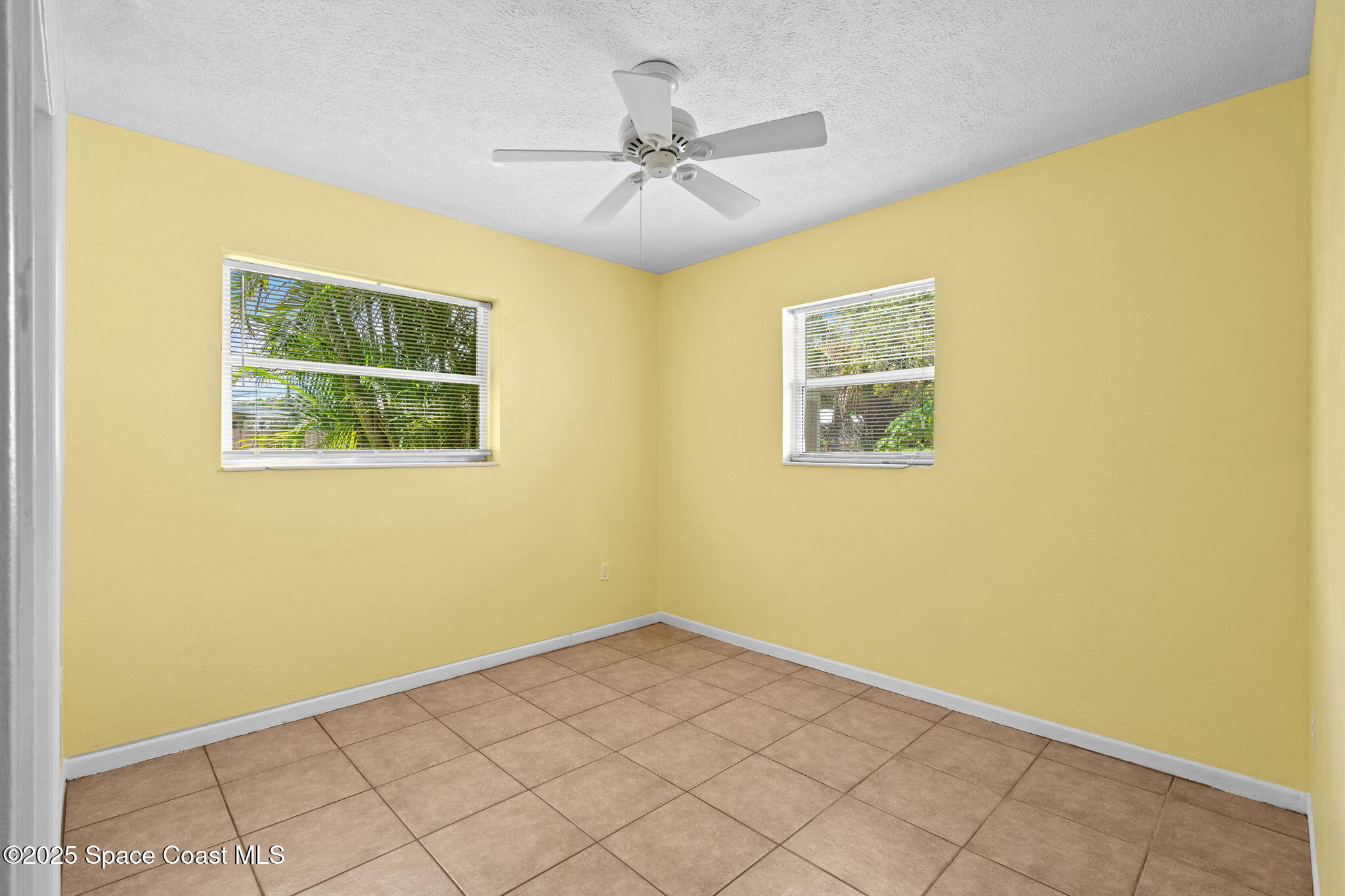 2902 Emory Street Melbourne, FL 32901 - Photo 13 of 46 a view of a room with a window and a ceiling fan