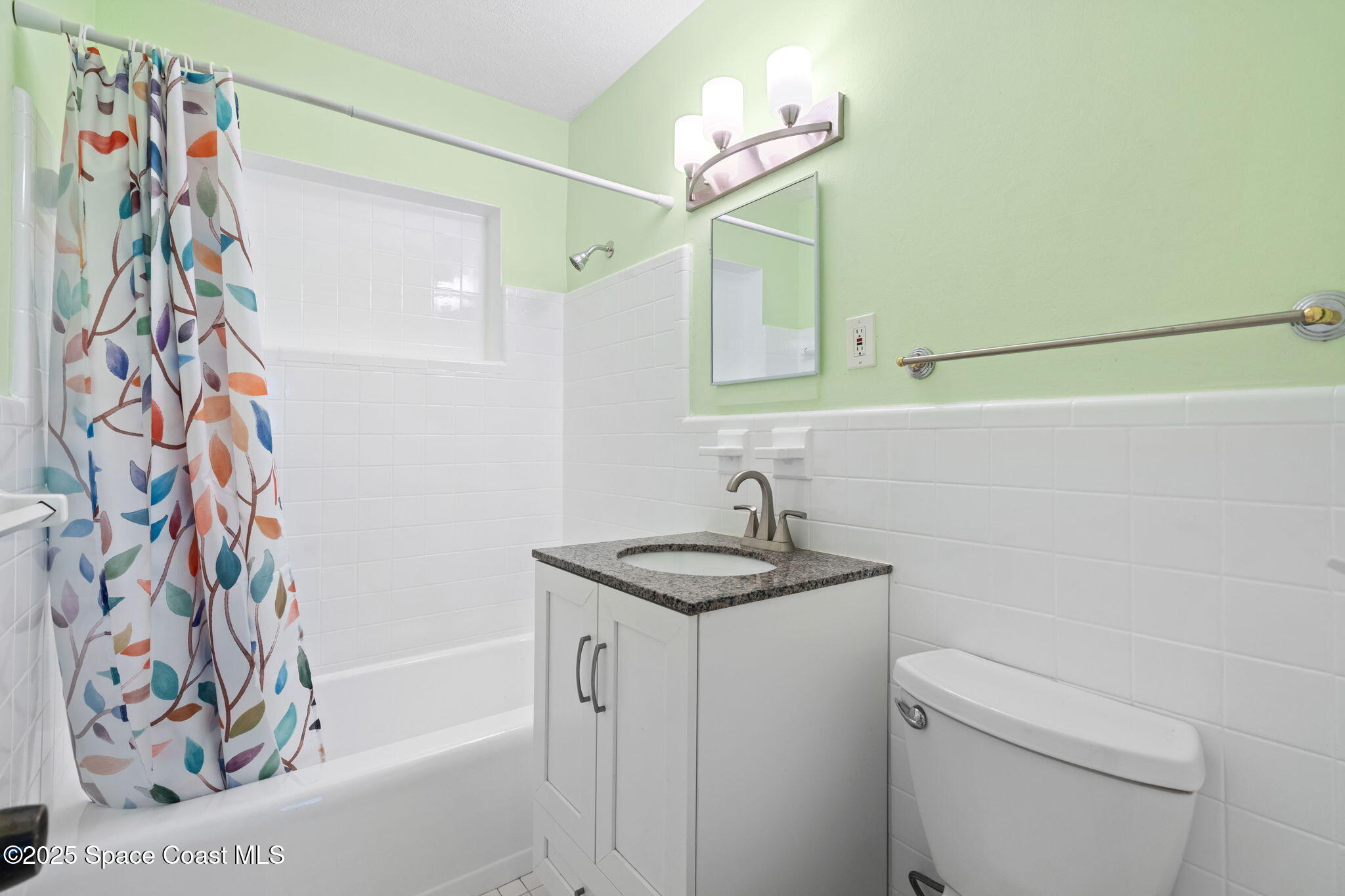 2902 Emory Street Melbourne, FL 32901 - Photo 14 of 46 a bathroom with a sink a toilet and shower curtain