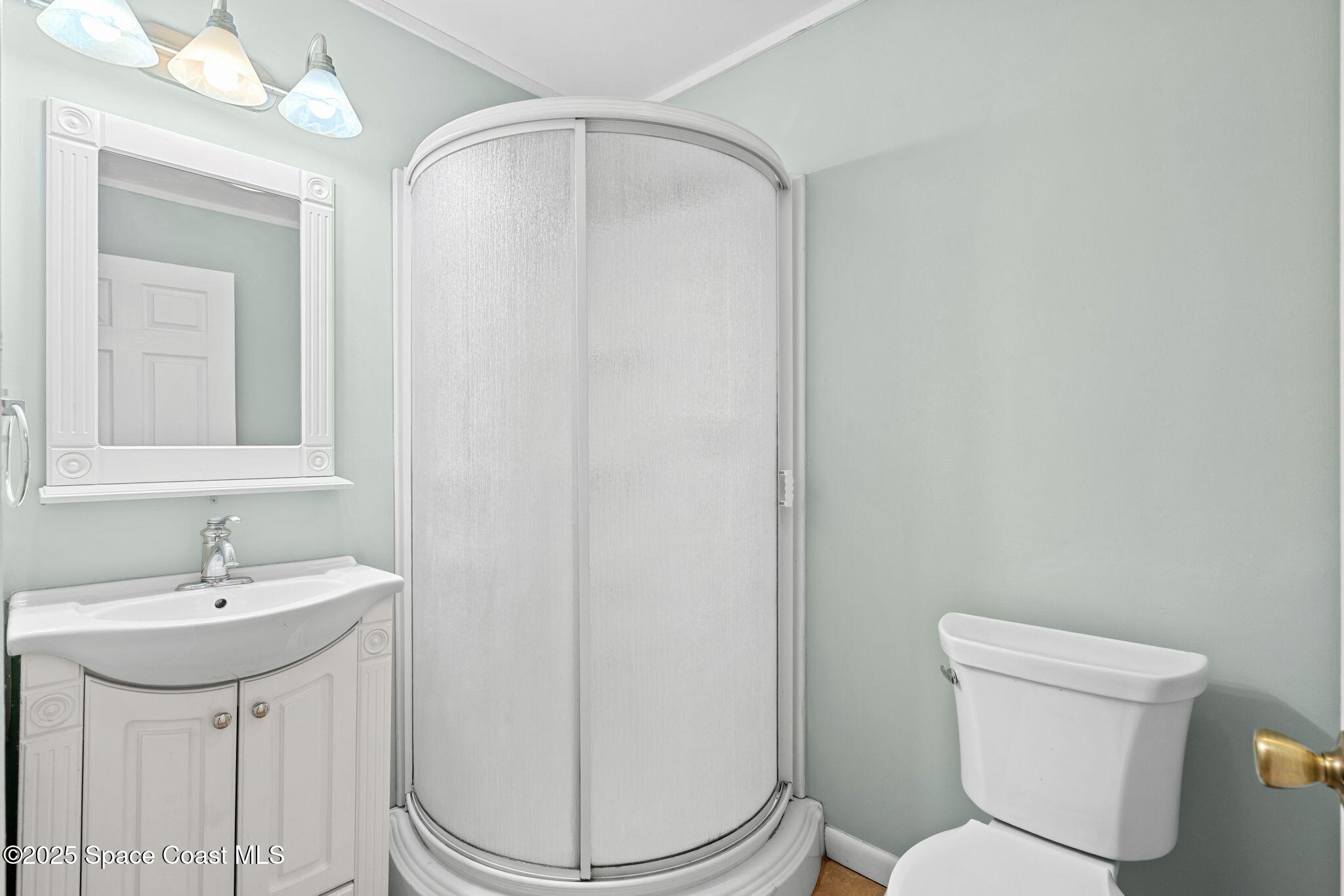 2902 Emory Street Melbourne, FL 32901 - Photo 20 of 46 a bathroom with a toilet a sink and a mirror