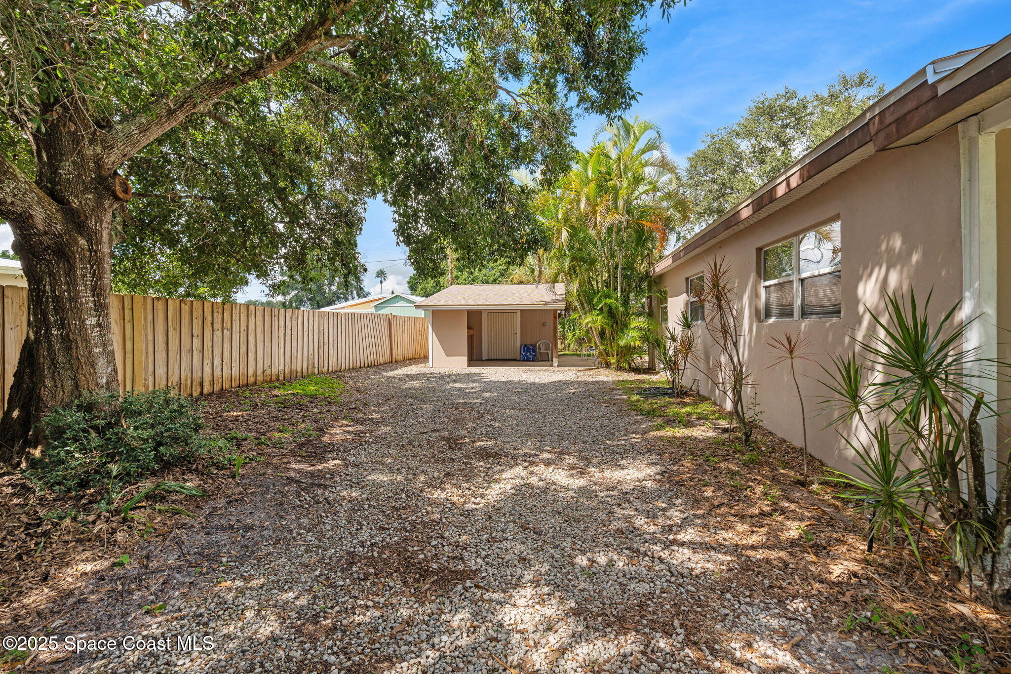 2902 Emory Street Melbourne, FL 32901 - Photo 26 of 46 a view of a yard with a house and a large tree