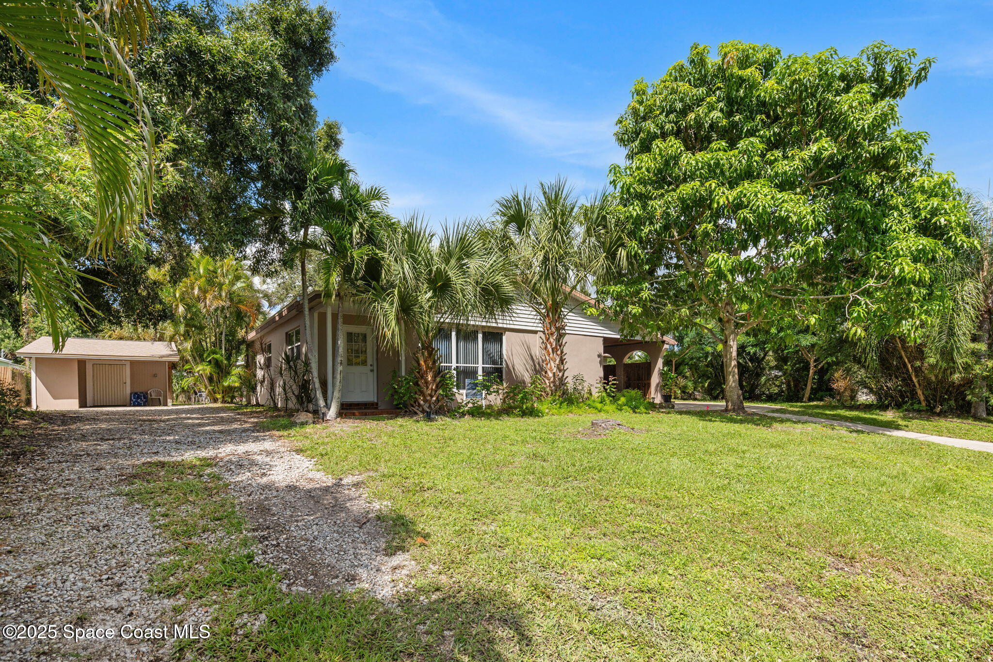 2902 Emory Street Melbourne, FL 32901 - Photo 3 of 46 a front view of a house with a yard and trees