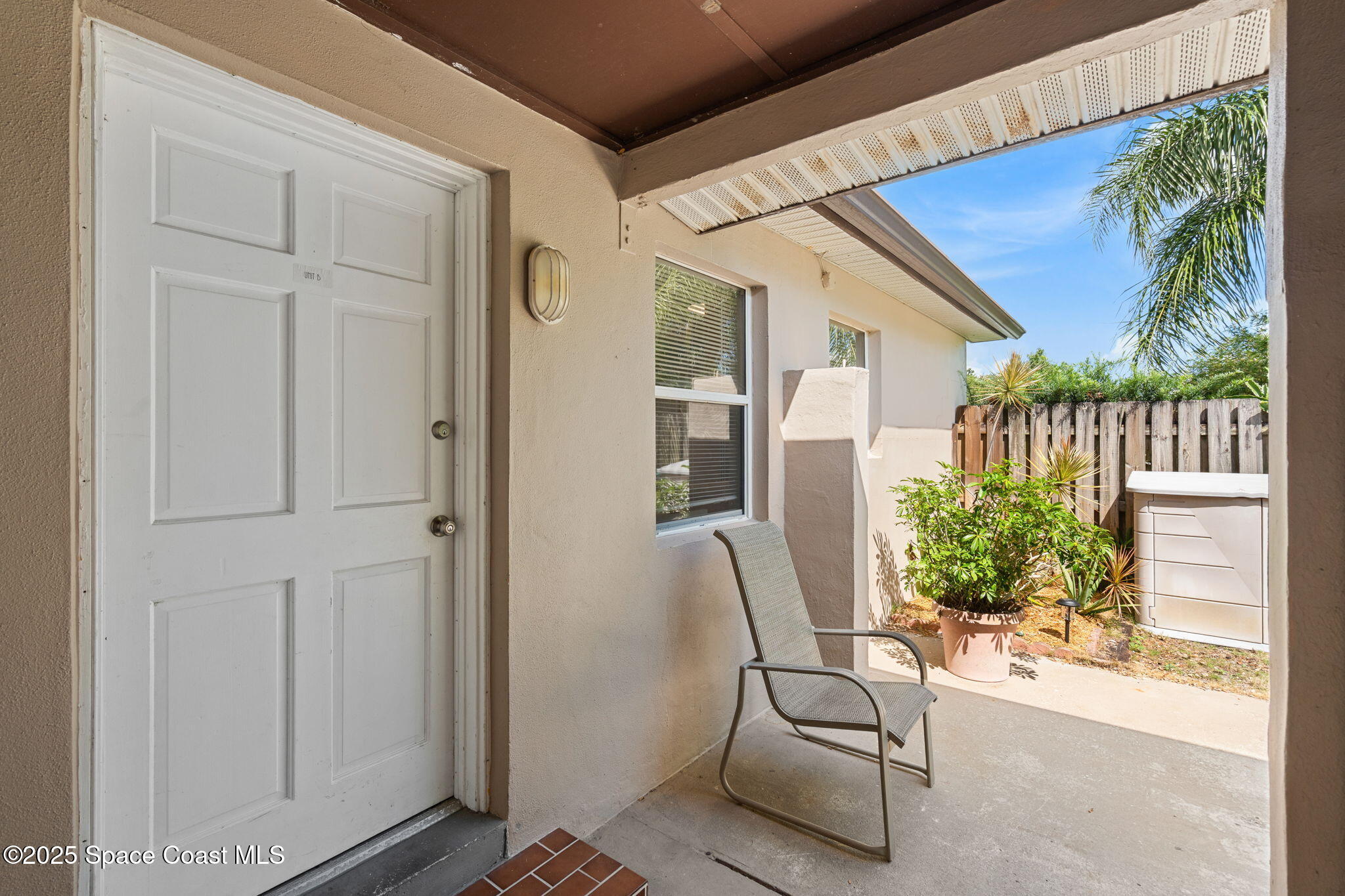 2902 Emory Street Melbourne, FL 32901 - Photo 30 of 46 a view of a balcony with chair and potted plants