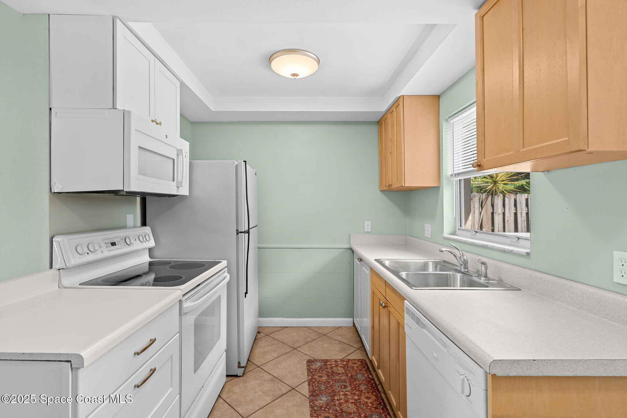2902 Emory Street Melbourne, FL 32901 - Photo 33 of 46 a kitchen that has a sink and a stove in it
