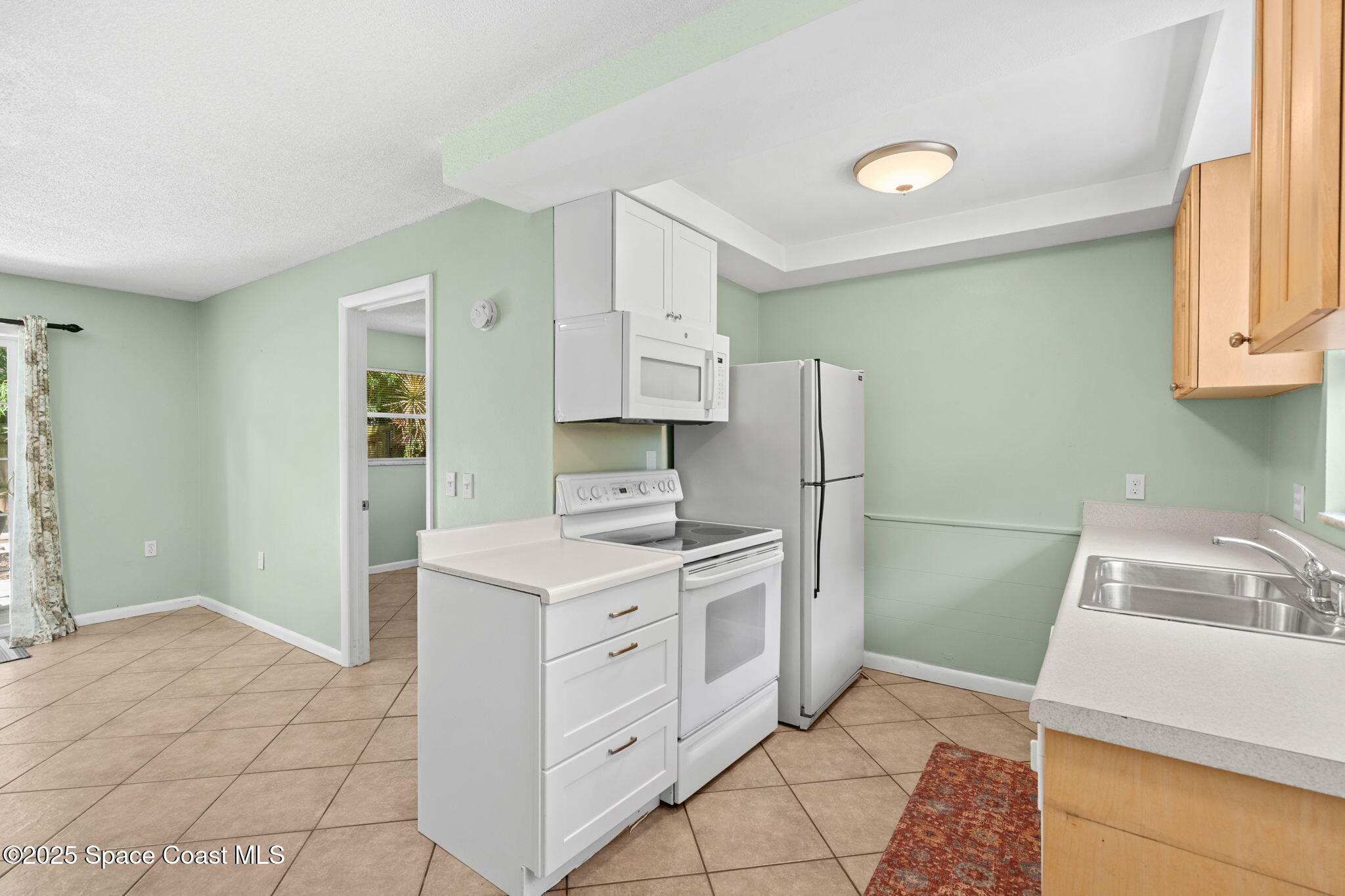 2902 Emory Street Melbourne, FL 32901 - Photo 34 of 46 a kitchen with a sink stove and refrigerator