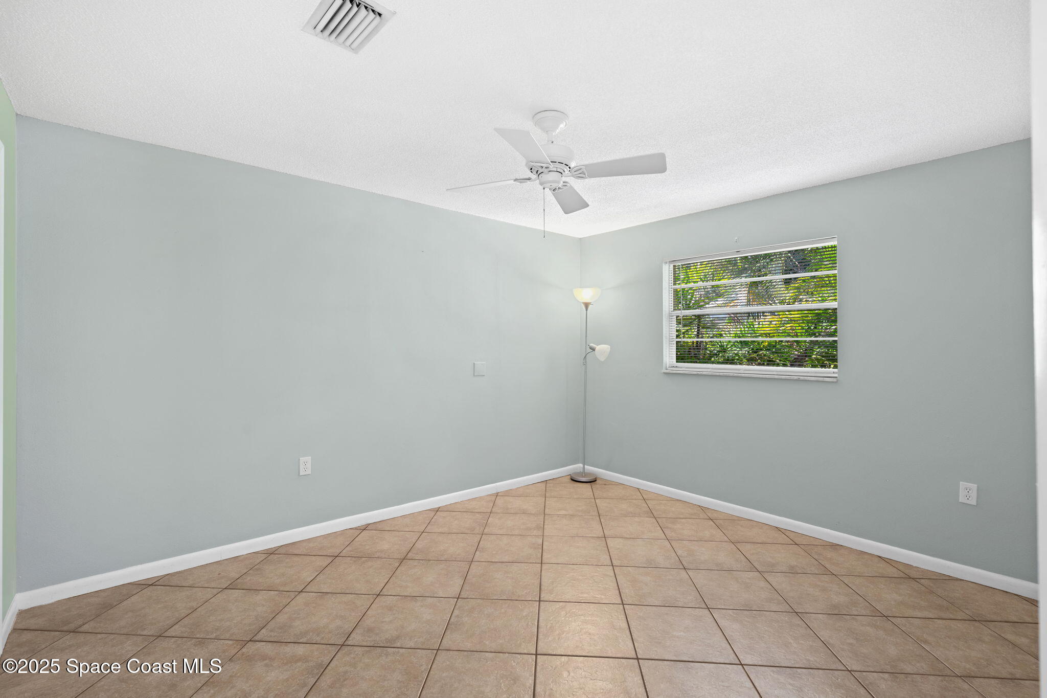 2902 Emory Street Melbourne, FL 32901 - Photo 37 of 46 an empty room with windows and fan